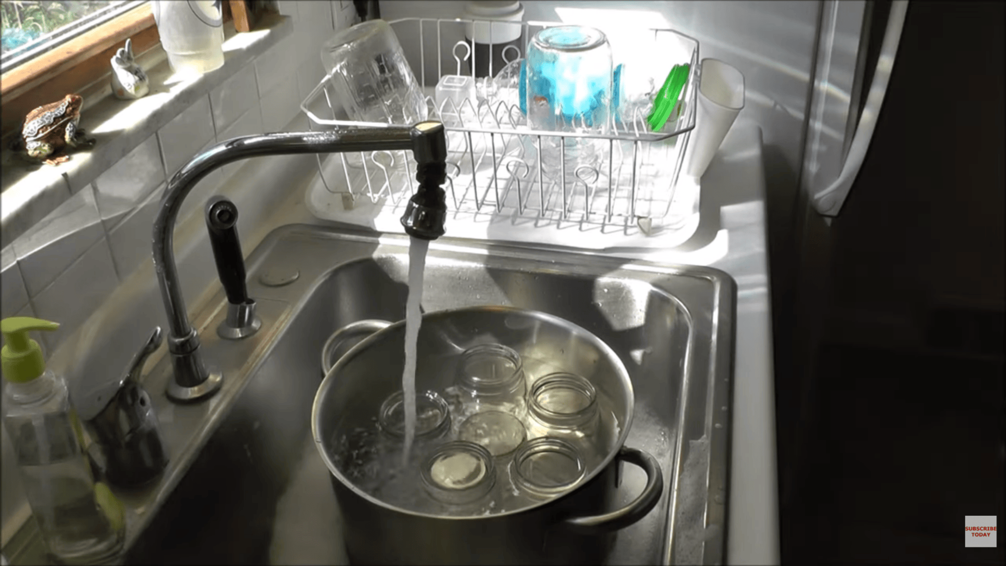 placing jars in pot with rack and filling with water for sterilizing