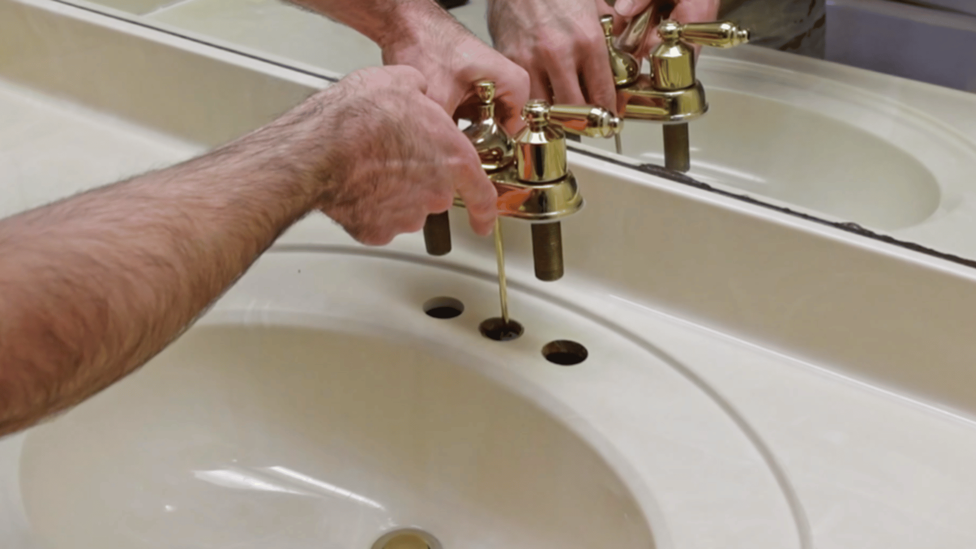 remove faucet, drain, and old caulk to prepare vanity surface for refinishing