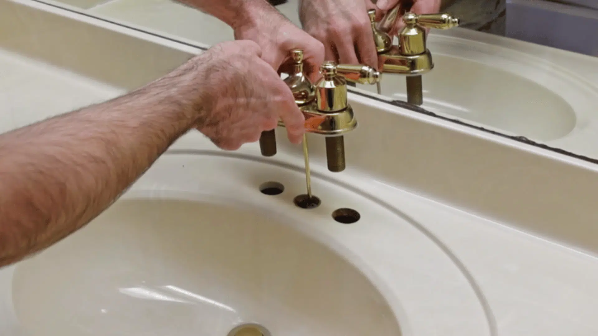 remove faucet, drain, and old caulk to prepare vanity surface for refinishing