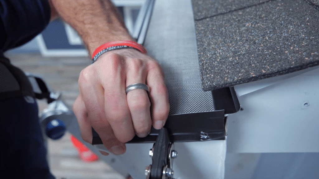 securing gutter guard edge and fitting it properly over gutter system.