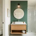 small master bathroom with green accent wall, floating vanity, and walk-in shower.