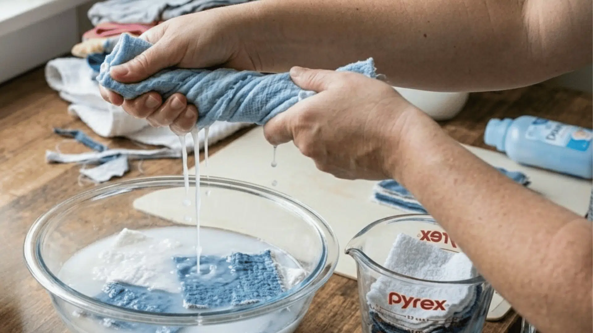 soaking and wringing cloth pieces in homemade dryer sheet mixture.