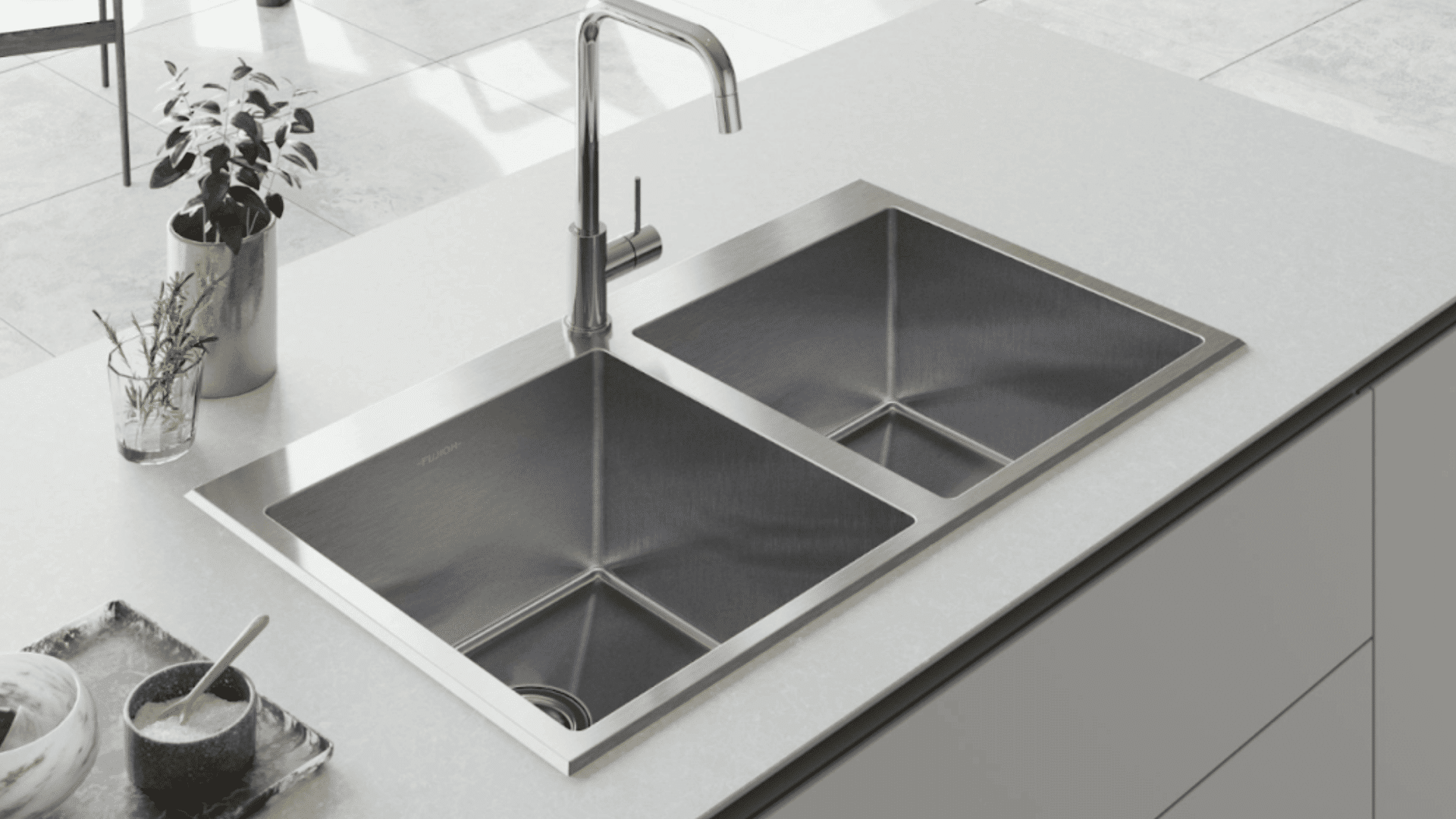 top mount sink with visible rim resting on countertop with clean empty basin and simple kitchen setup