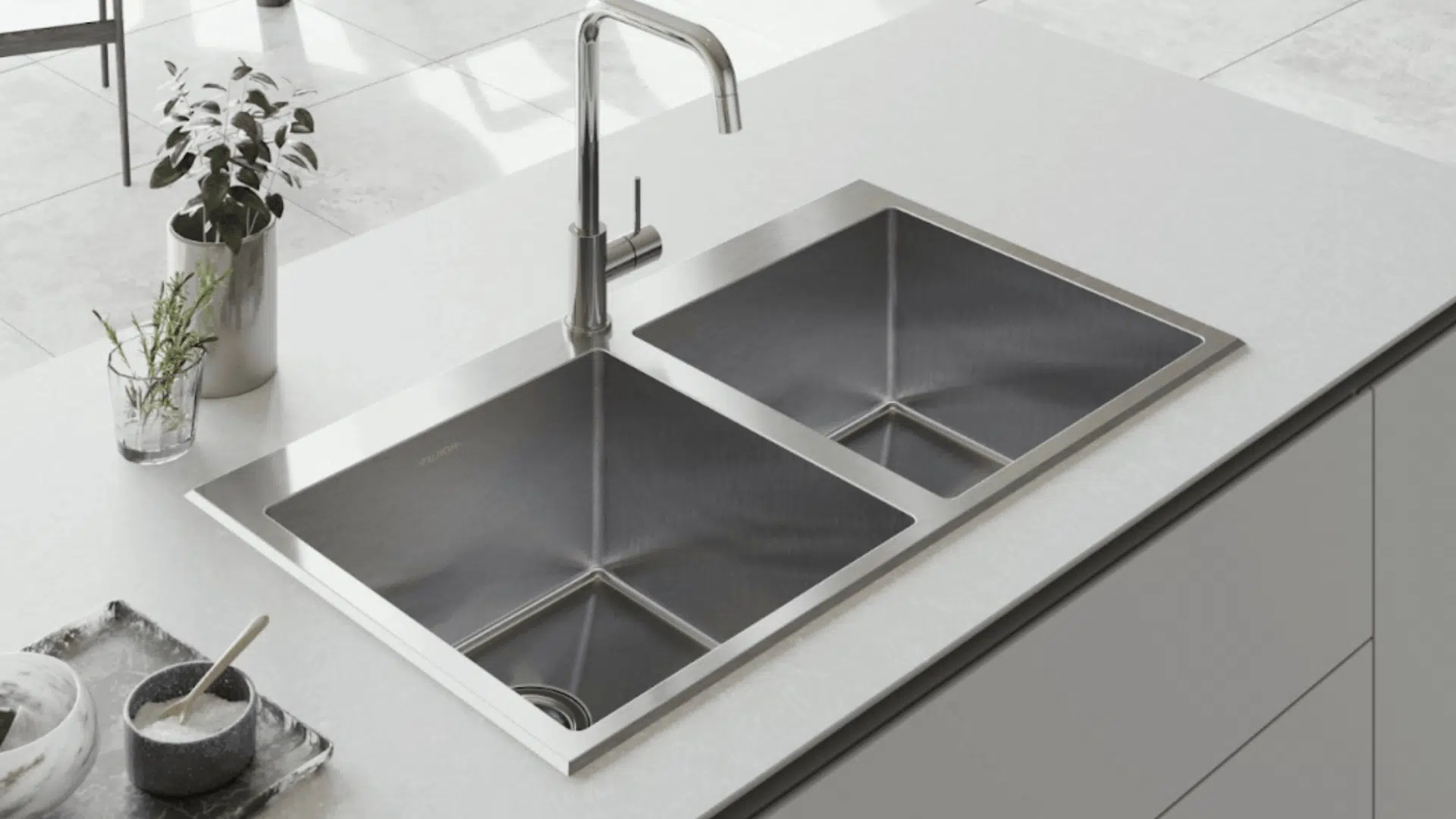 top mount sink with visible rim resting on countertop with clean empty basin and simple kitchen setup