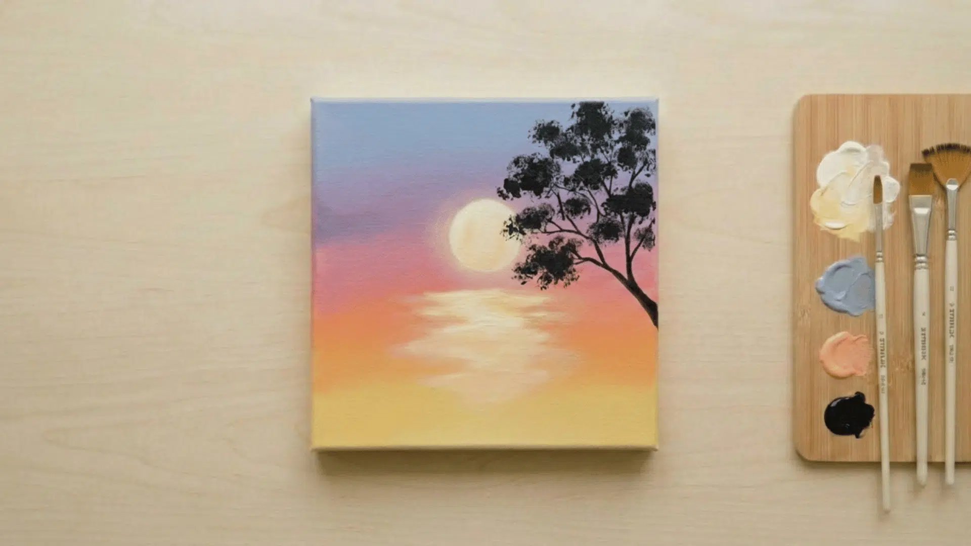 top view of hand painting tree silhouette on sunset canvas with black paint and palette