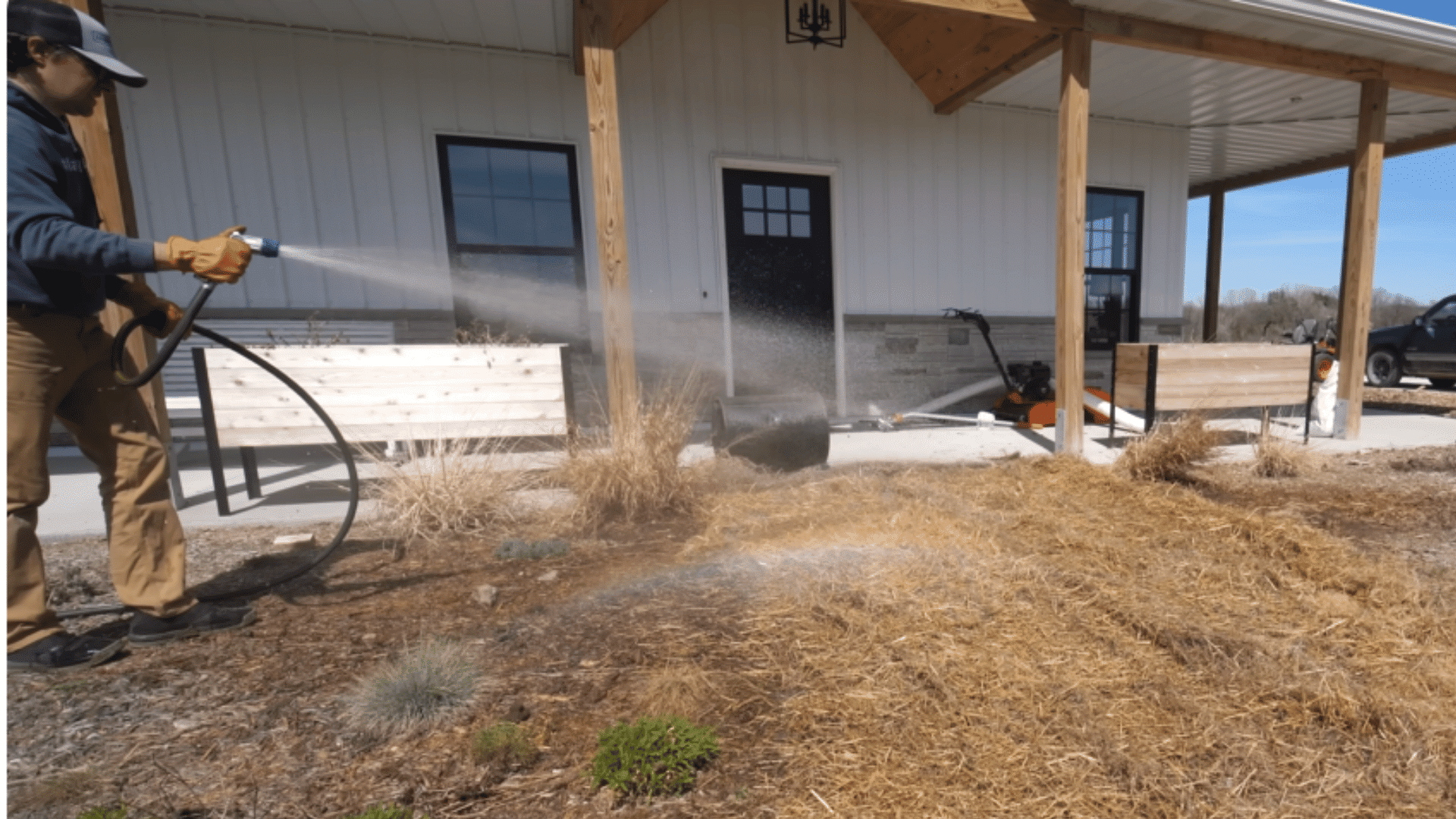 watering newly seeded lawn evenly to keep soil moist and support germination