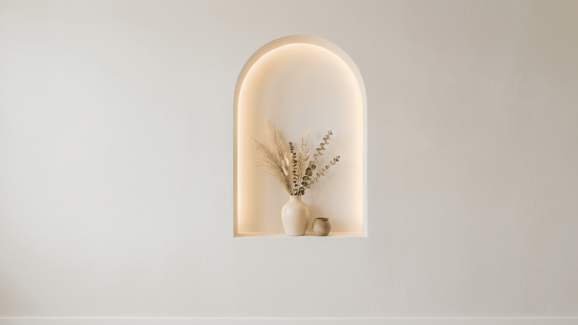 arched wall niche with soft lighting in a minimal interior