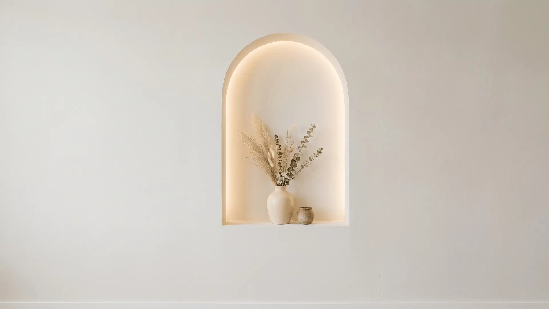 arched wall niche with soft lighting in a minimal interior