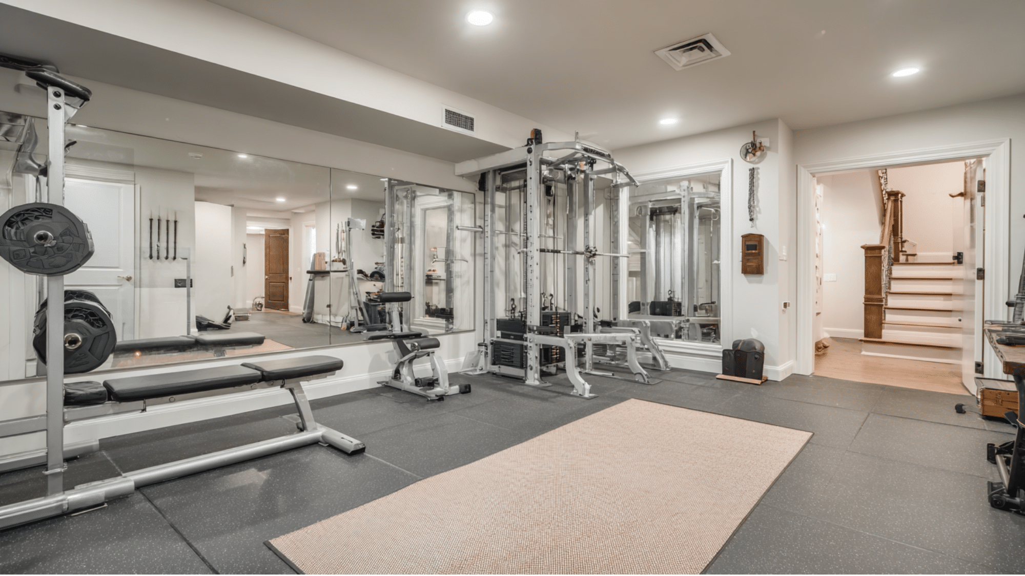 basement home gym with workout equipment and mirror wall