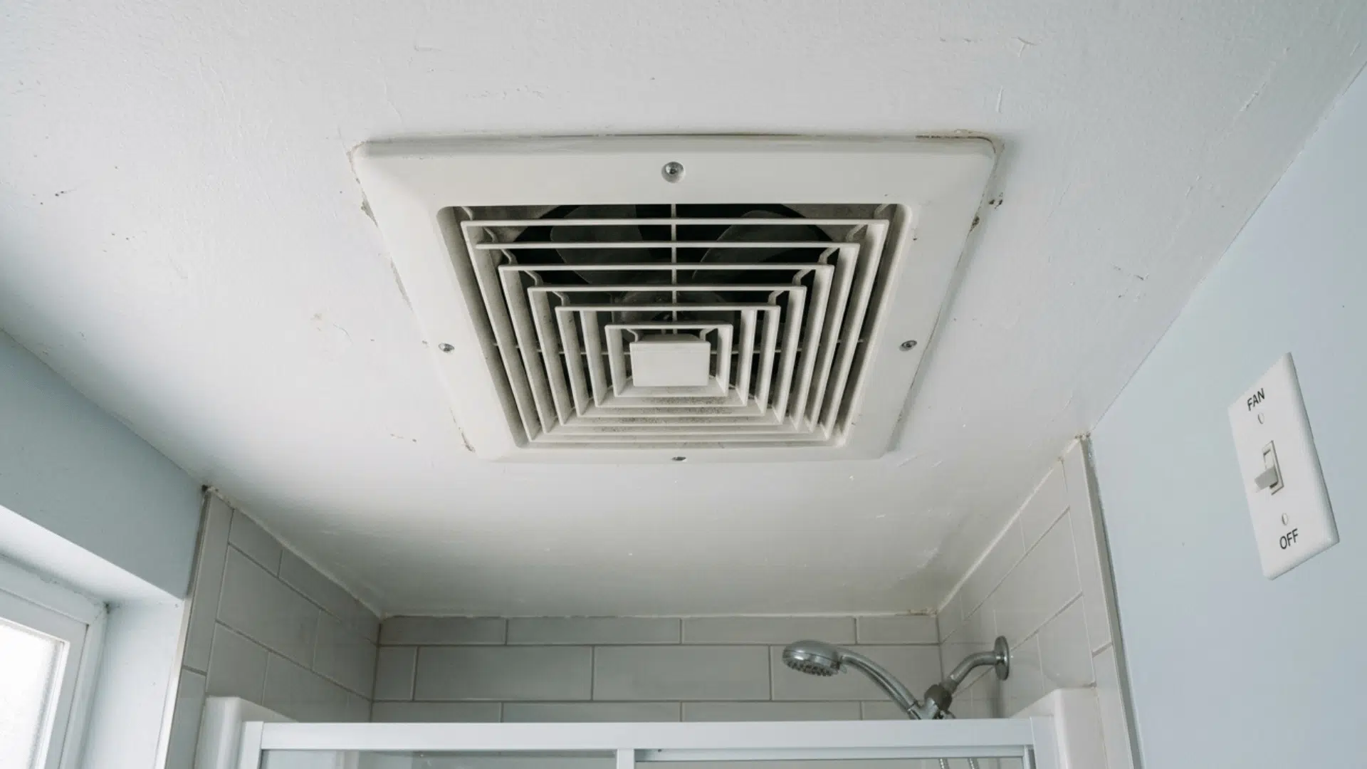 bathroom ceiling exhaust fan turned off above shower area.