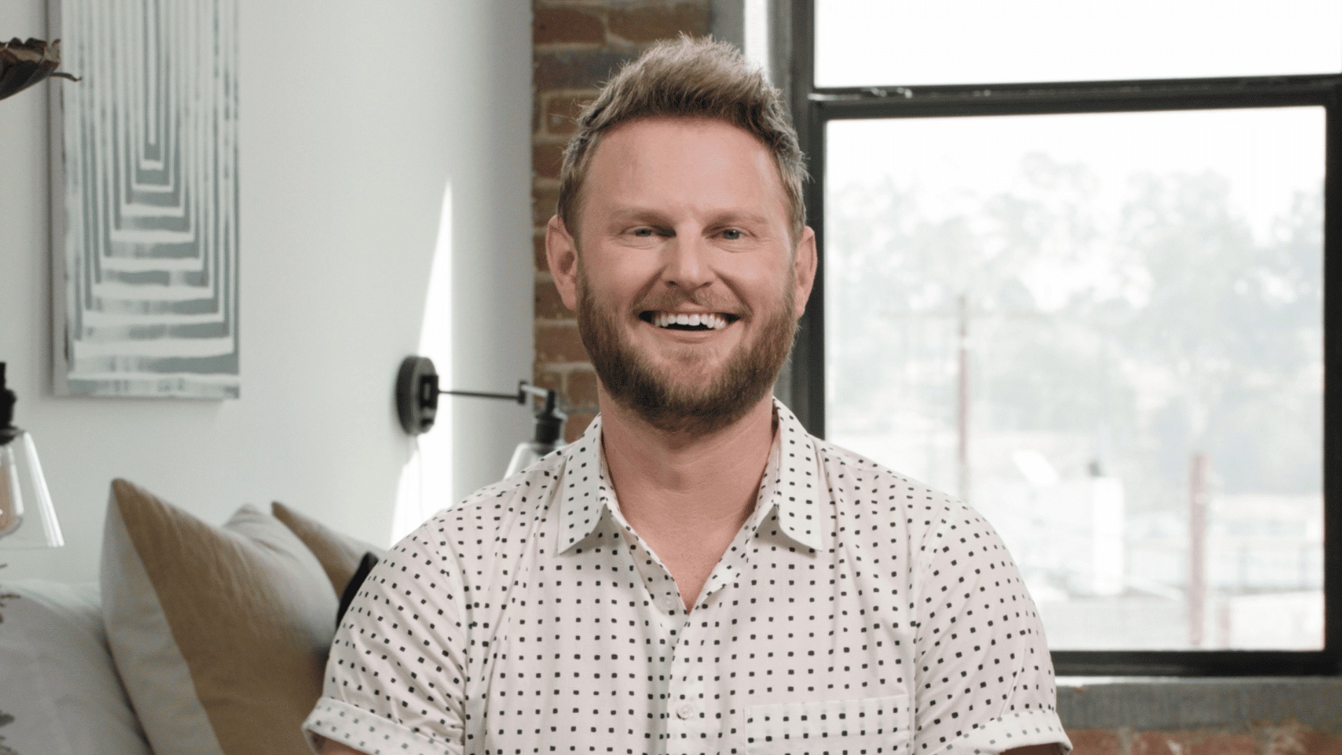 bobby berk in a clean and modern room focused on practical layout and simple interior design elements