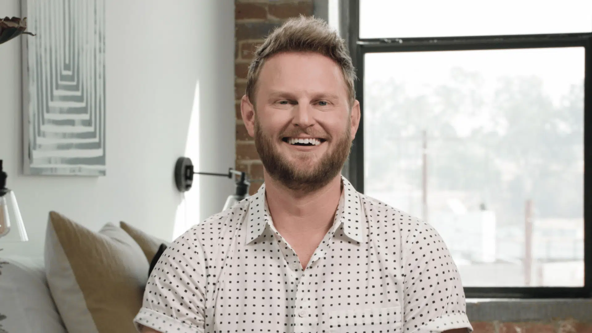 bobby berk in a clean and modern room focused on practical layout and simple interior design elements