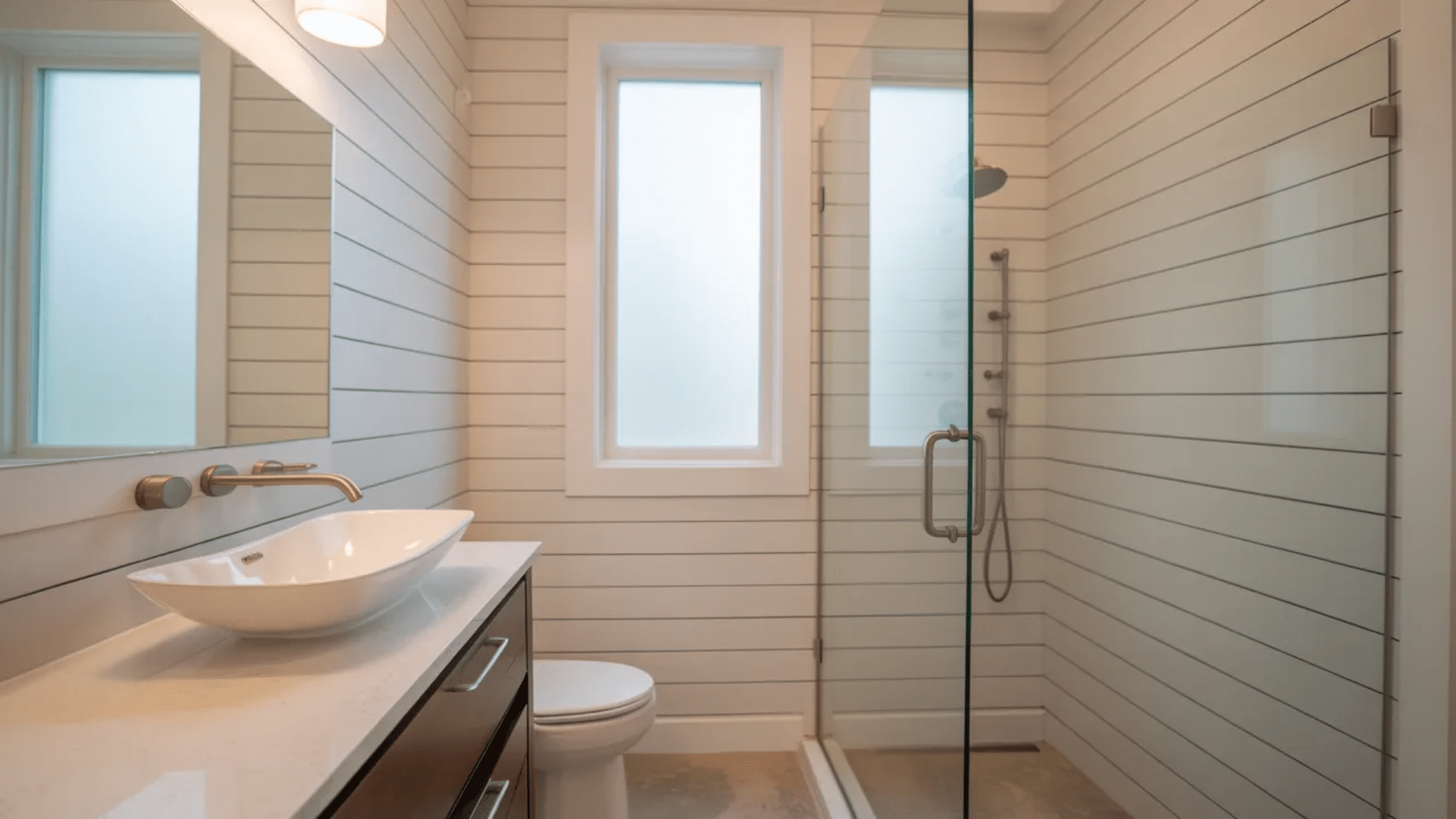bright bathroom with vaulted wood plank wall large window glass door to outdoor view