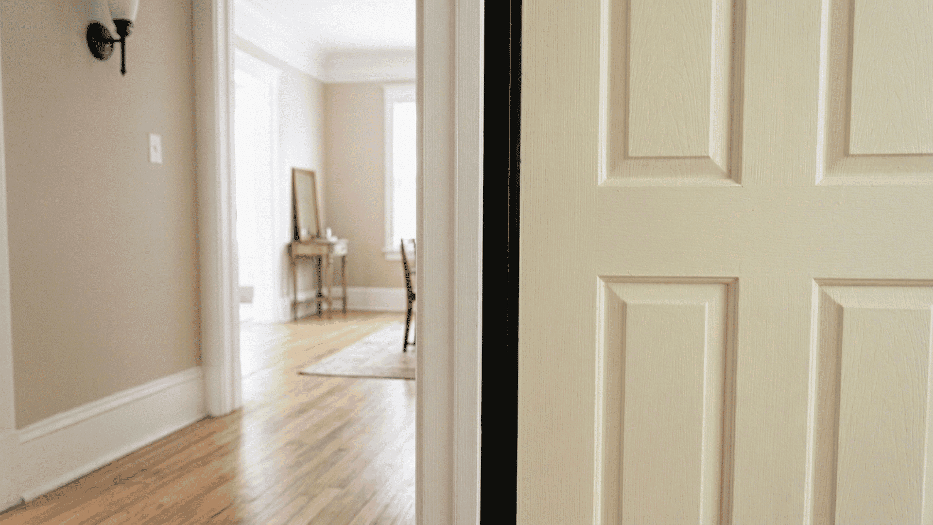 clean black weather stripping pressed firmly along the inside edge of a wooden interior door frame