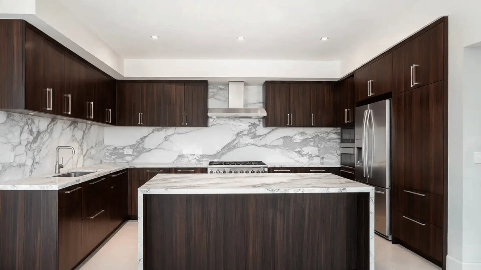 contemporary kitchen with dark wooden cabinets marble countertops and island