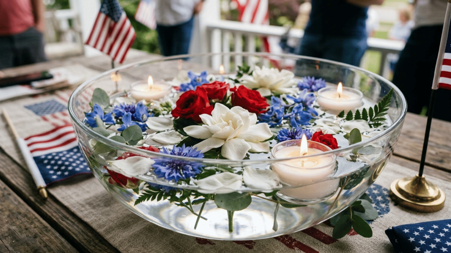 floating flower bowl centerpiece with candles and red, white, and blue blooms.