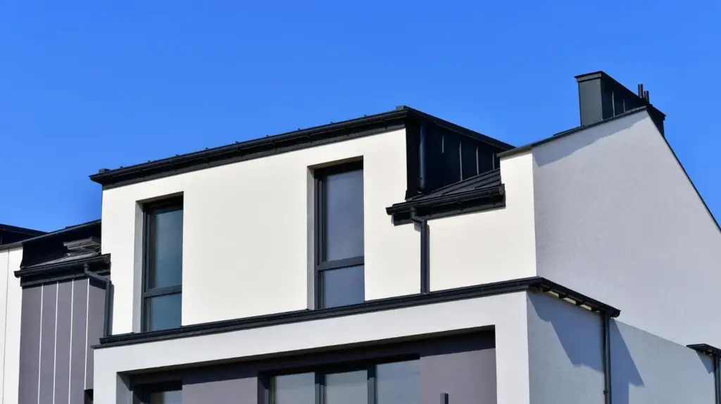 Modern white facade building with large windows under clear blue sky
