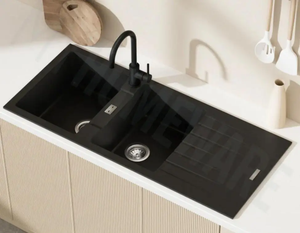 Black kitchen sink with modern faucet and cutting board on light counter