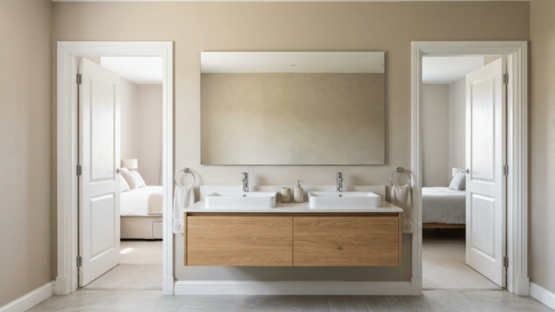 jack and jill bathroom with double sink vanity and wall mirror with soft wall reflection and clean layout