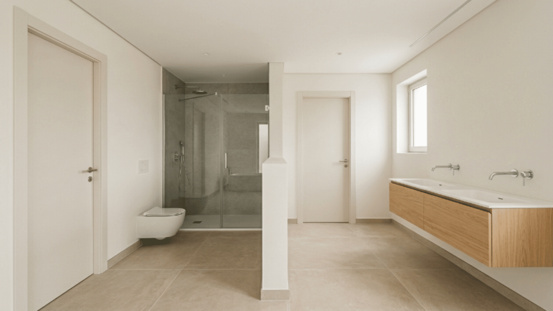 jack and jill bathroom with half wall separating vanity and bath areas