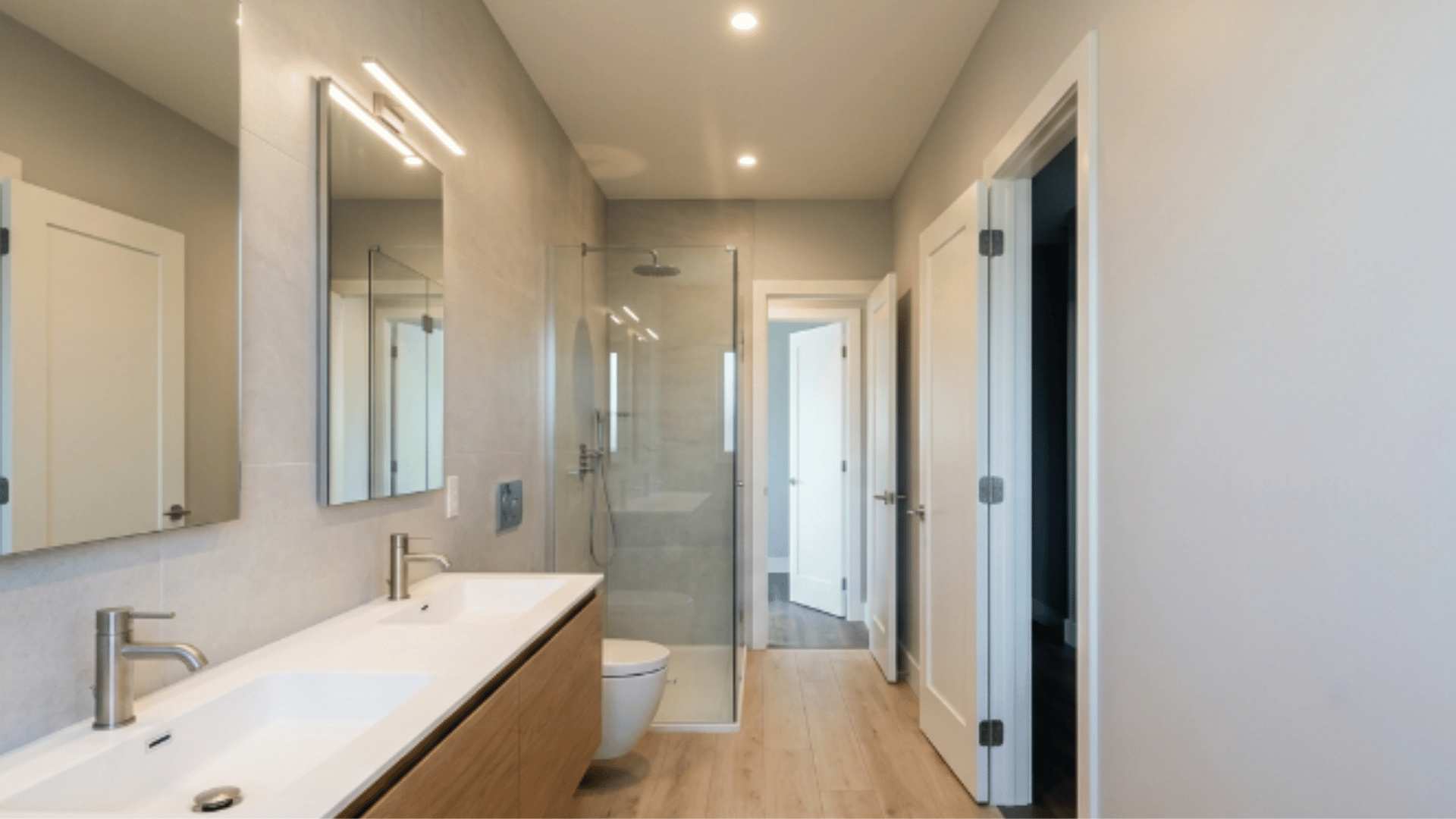jack and jill bathroom with long corridor layout and fixtures aligned along one wall