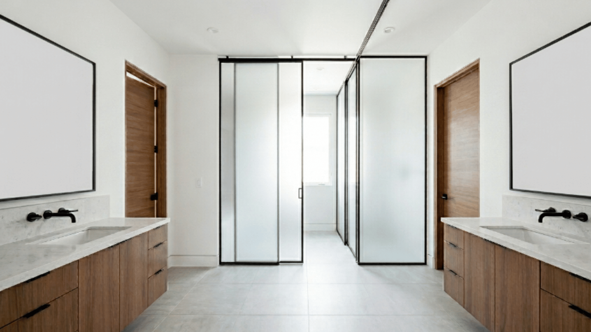 jack and jill bathroom with sliding glass panels dividing the space