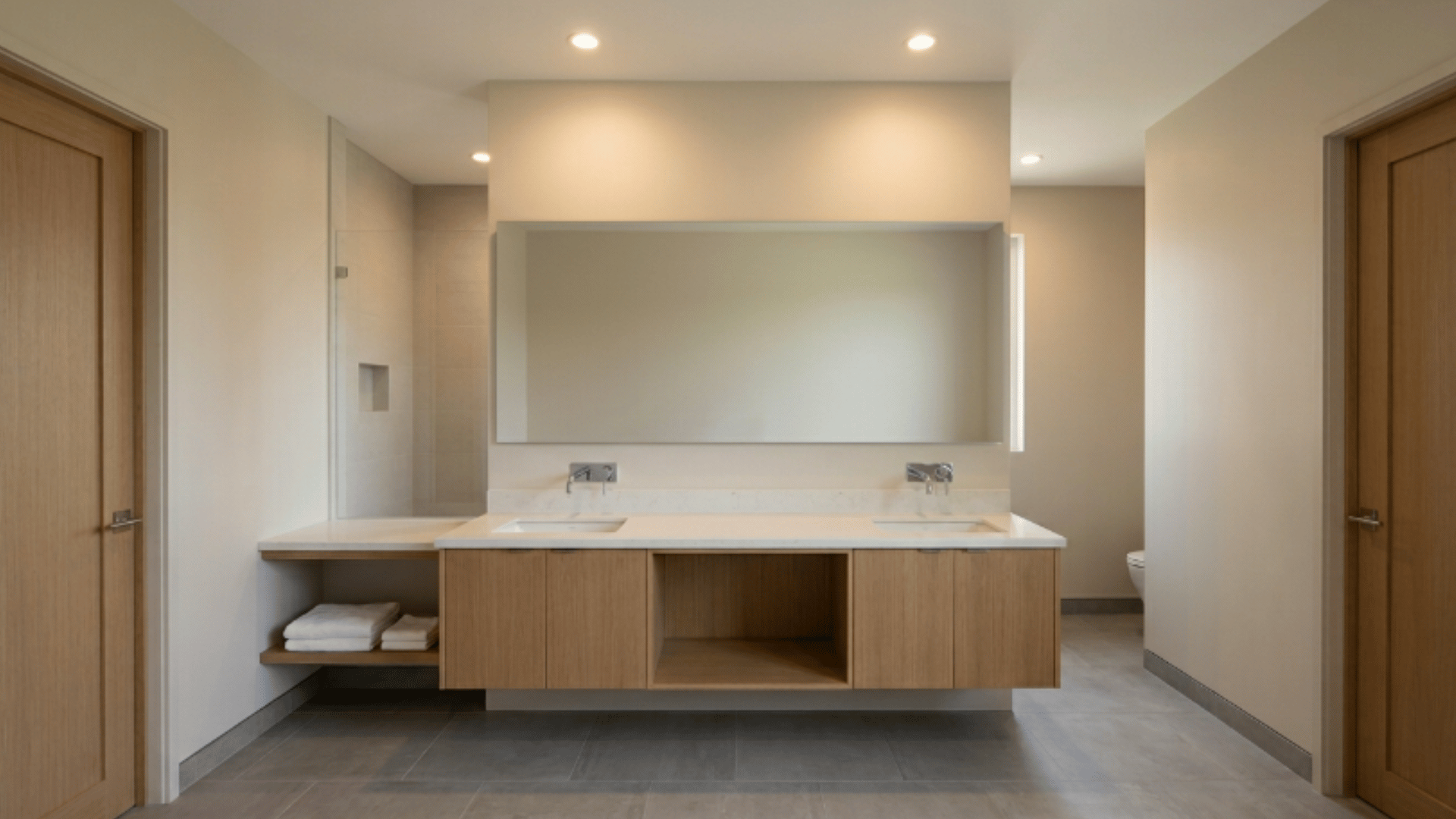 jack and jill bathroom with two sinks and one long shared mirror
