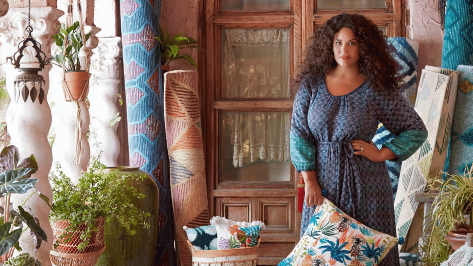 justina blakeney in a colorful boho inspired space filled with plants and vibrant decor (1)