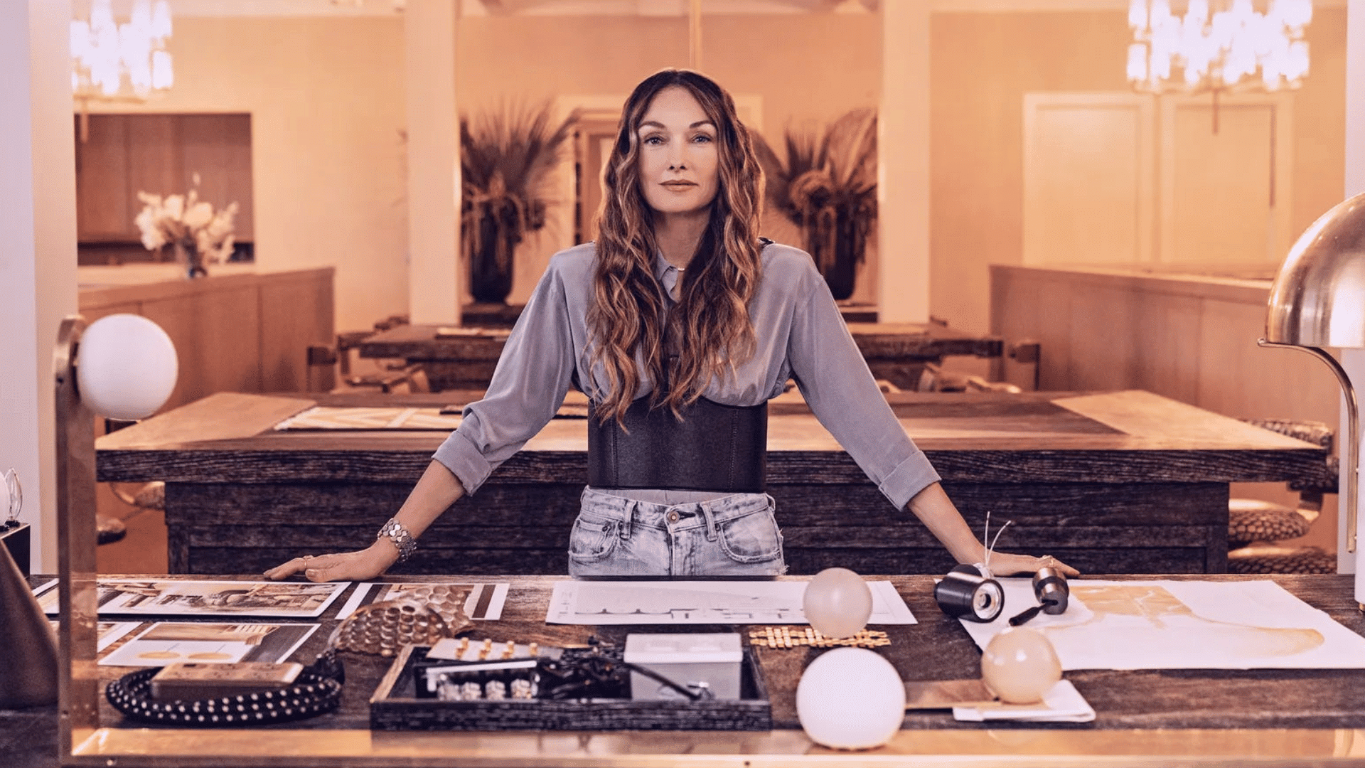 kelly wearstler posing in a bold and textured luxury interior showcasing her signature layered design style (1)