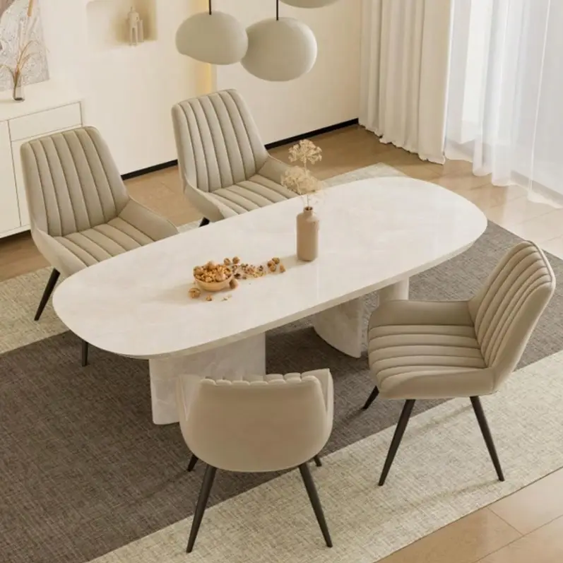 Modern dining room with beige chairs around oval marble table and decorative centerpiece