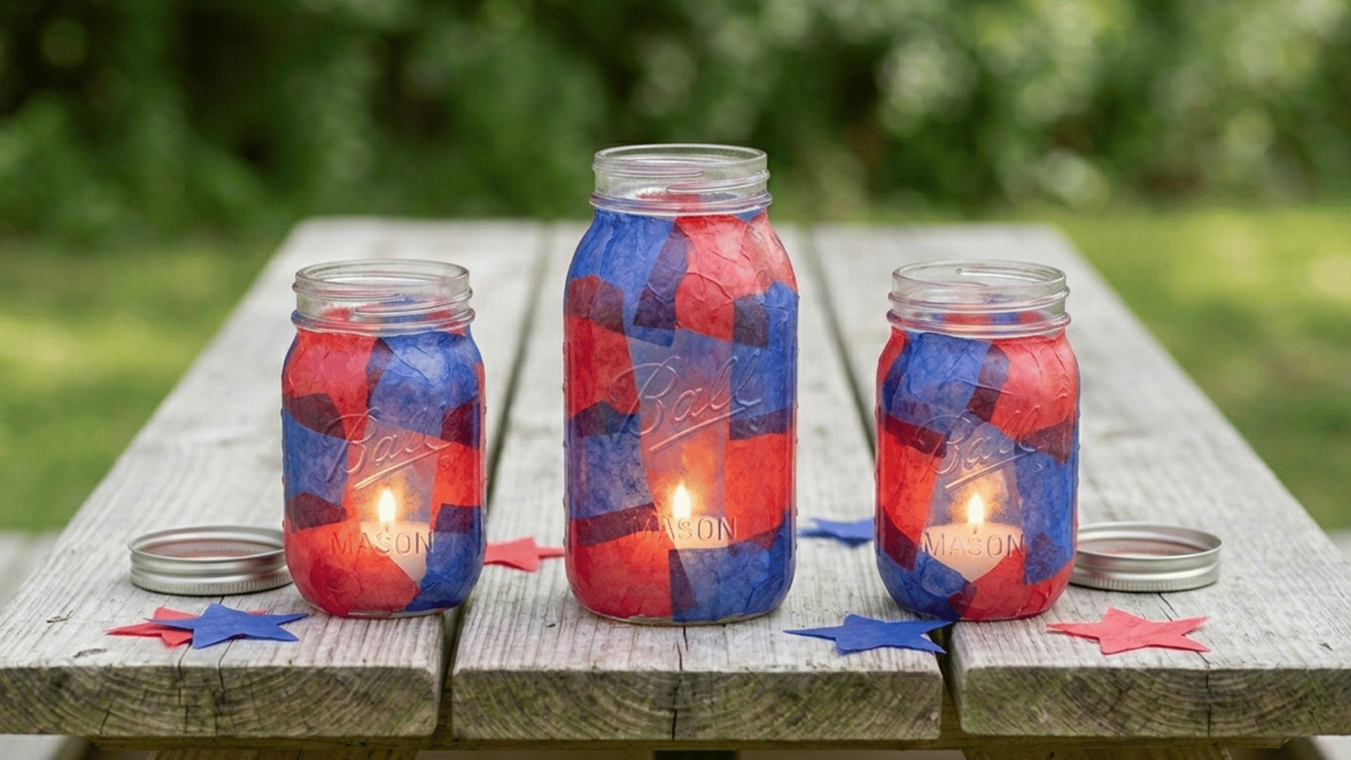 red and blue tissue paper mason jar candle holders with soft glow.
