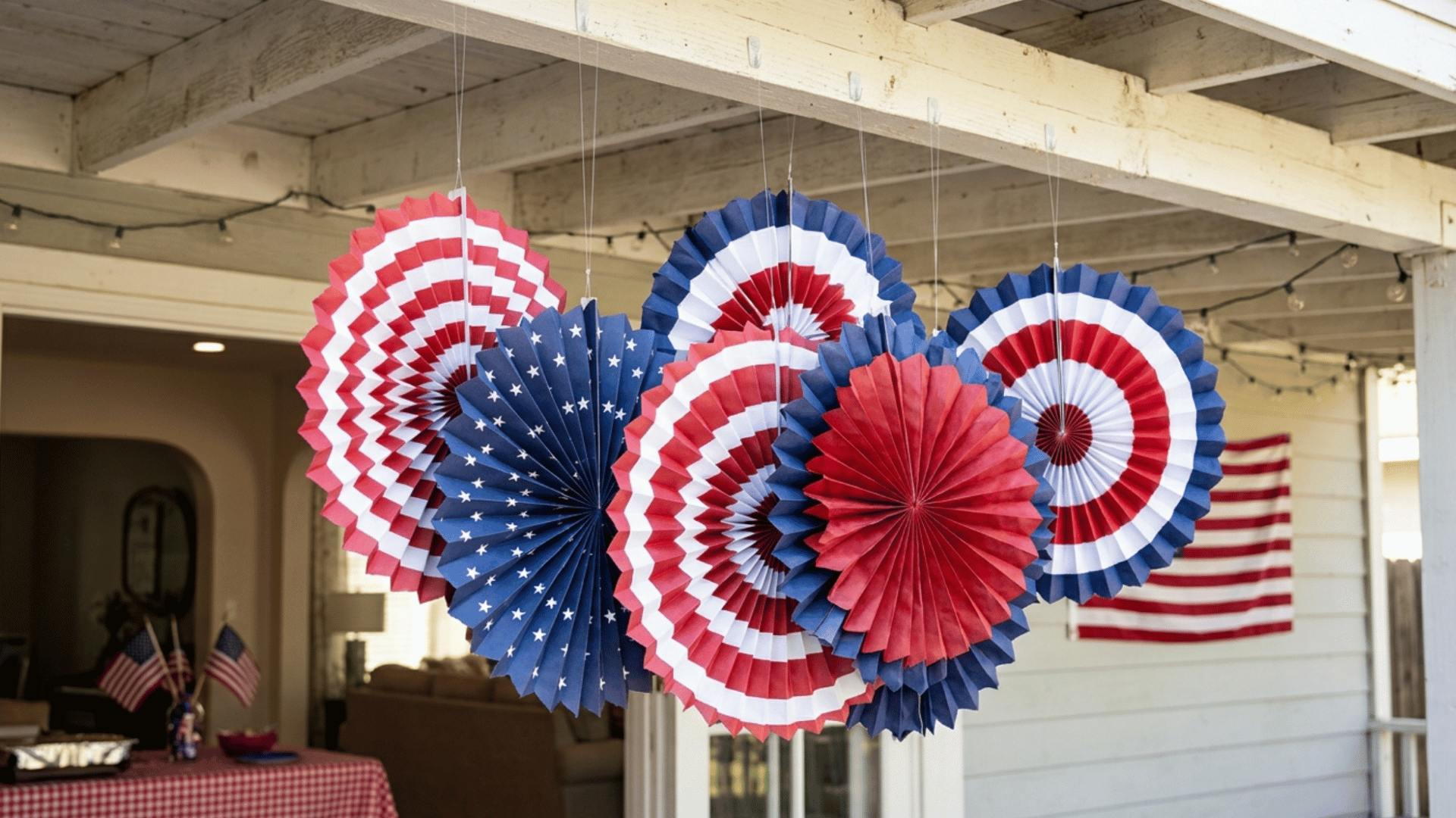 red white blue paper fans hanging, creating simple patriotic backdrop for memorial day decor setup