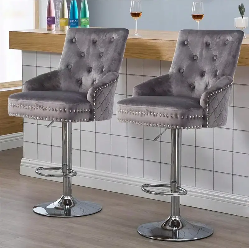 Two gray velvet bar stools with chrome bases in modern kitchen setting