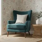 Teal armchair with white pillow next to wicker side table and vase in cozy room