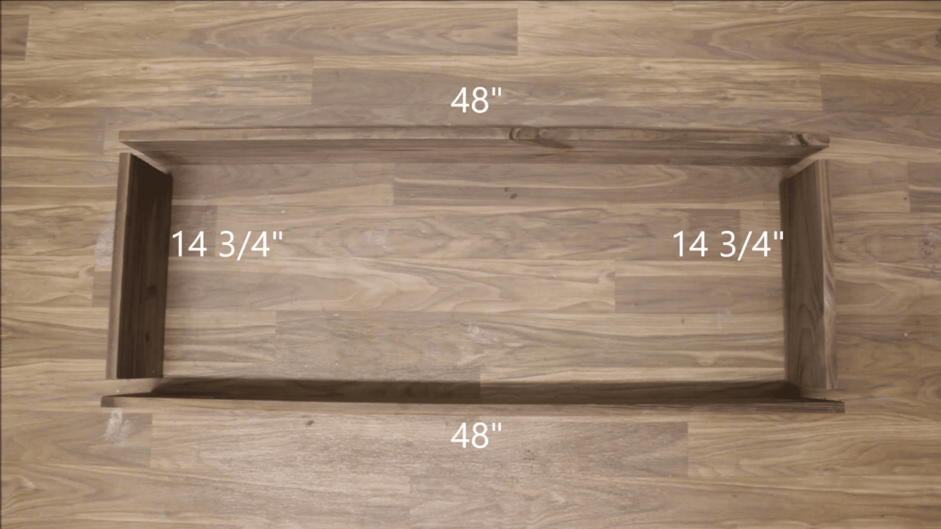 cutting boards into specific sizes sitting on a wooden furnished floor for assembly with markings