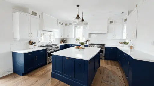 modern white kitchen with navy blue lower cabinets and island white quartz countertops brass hardware hardwood floors and pendant lighting with bright natural light
