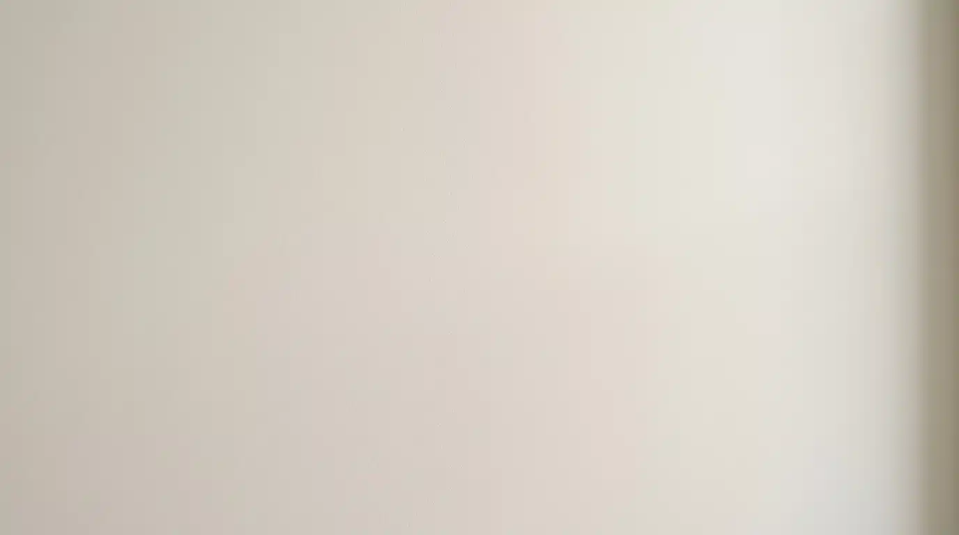 subtle, light beige or off-white textured background with soft, diffused lighting