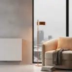 Cozy beige armchair with knit blanket next to floor lamp in modern minimalist living room