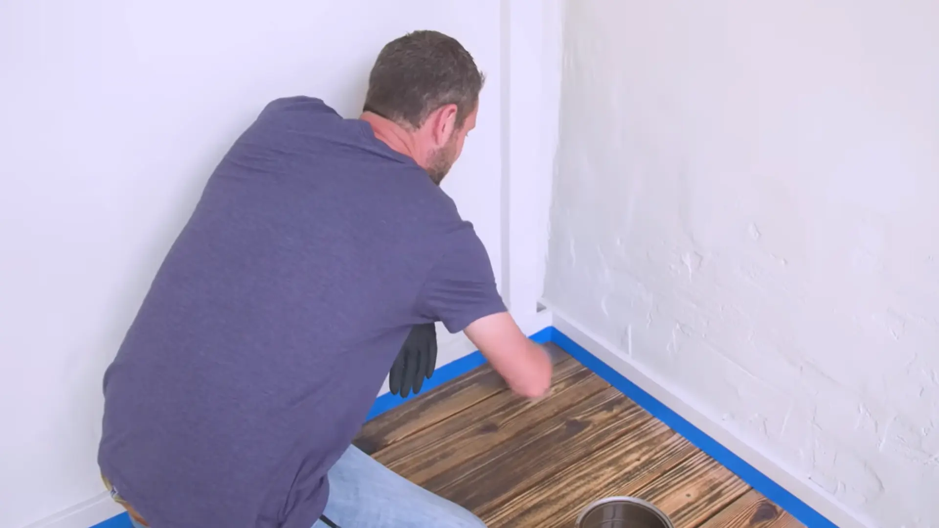 a brush to apply stain around deck posts