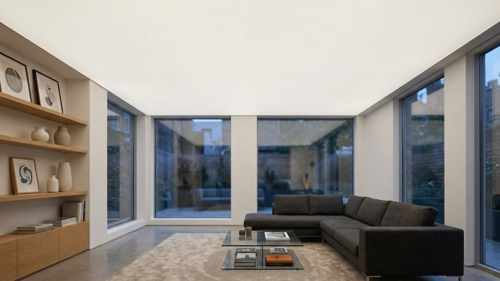 A modern living room with seamless stretched ceiling in smooth matte finish.