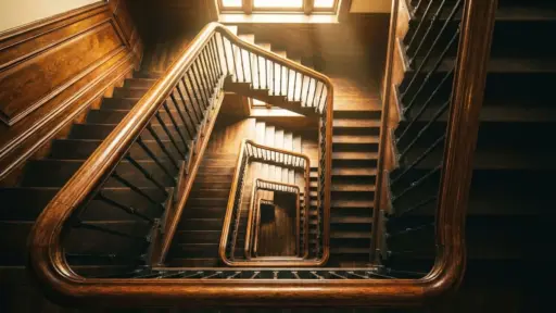 classic wooden flight of stairs with multiple landings inside historic multi story building hall hub