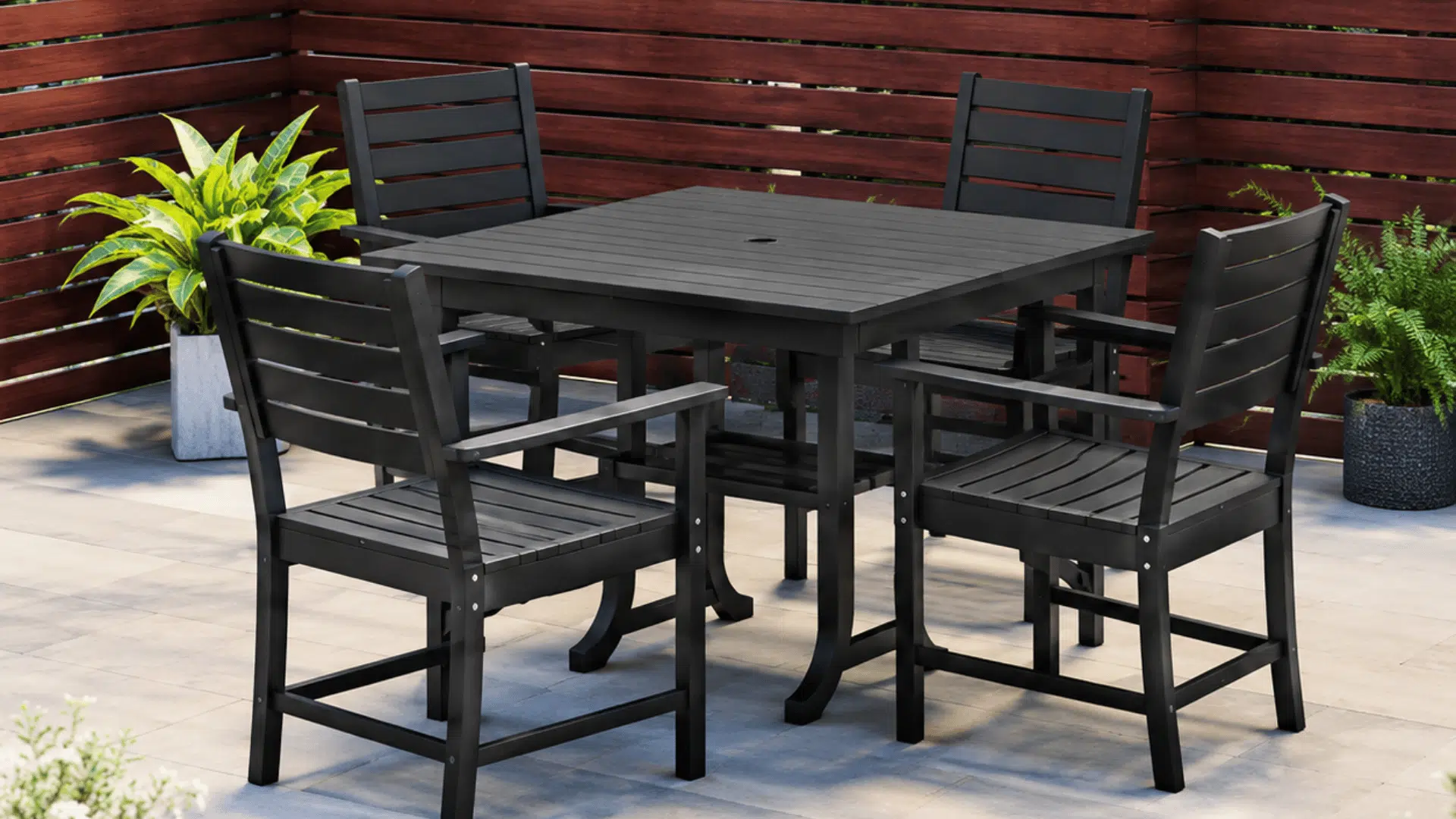 compact black outdoor dining set with square table and four chairs on tiled backyard patio