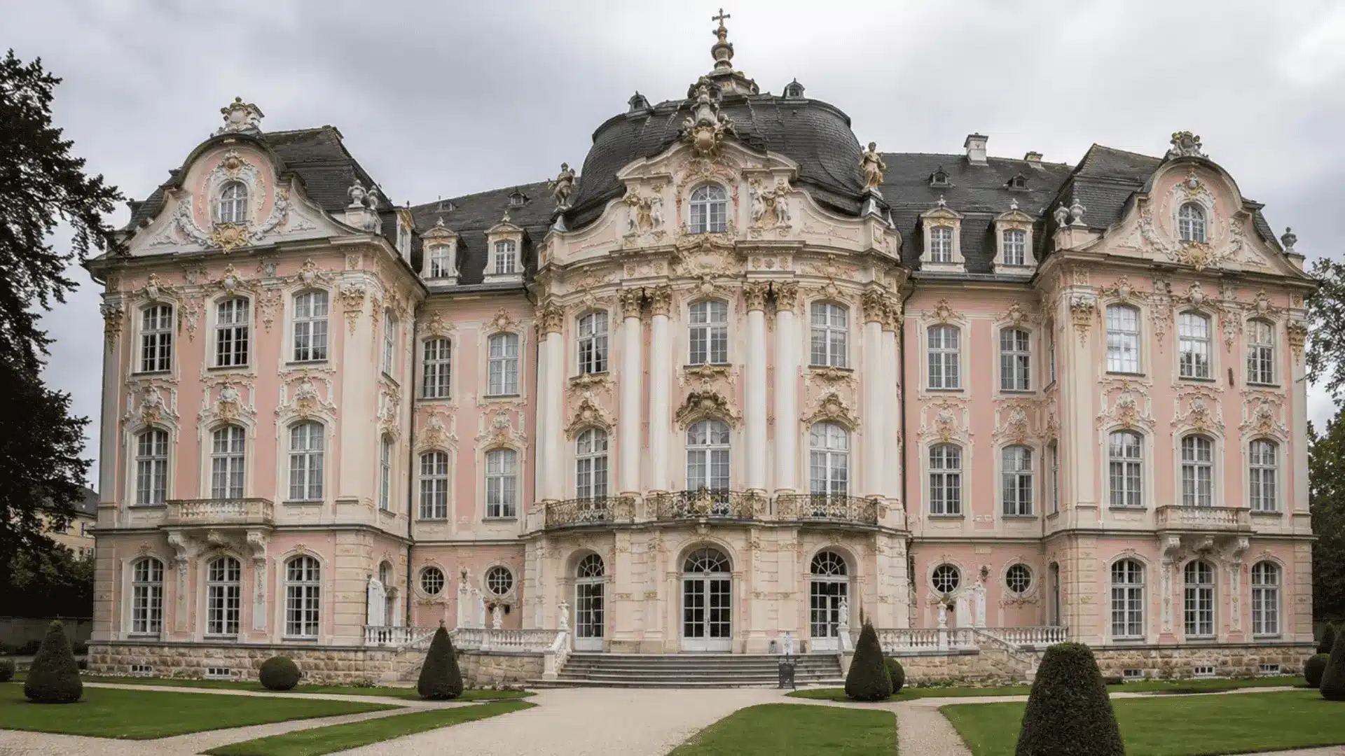 pink and gold rococo palace with a curved central pavilion columns and manicured garden paths
