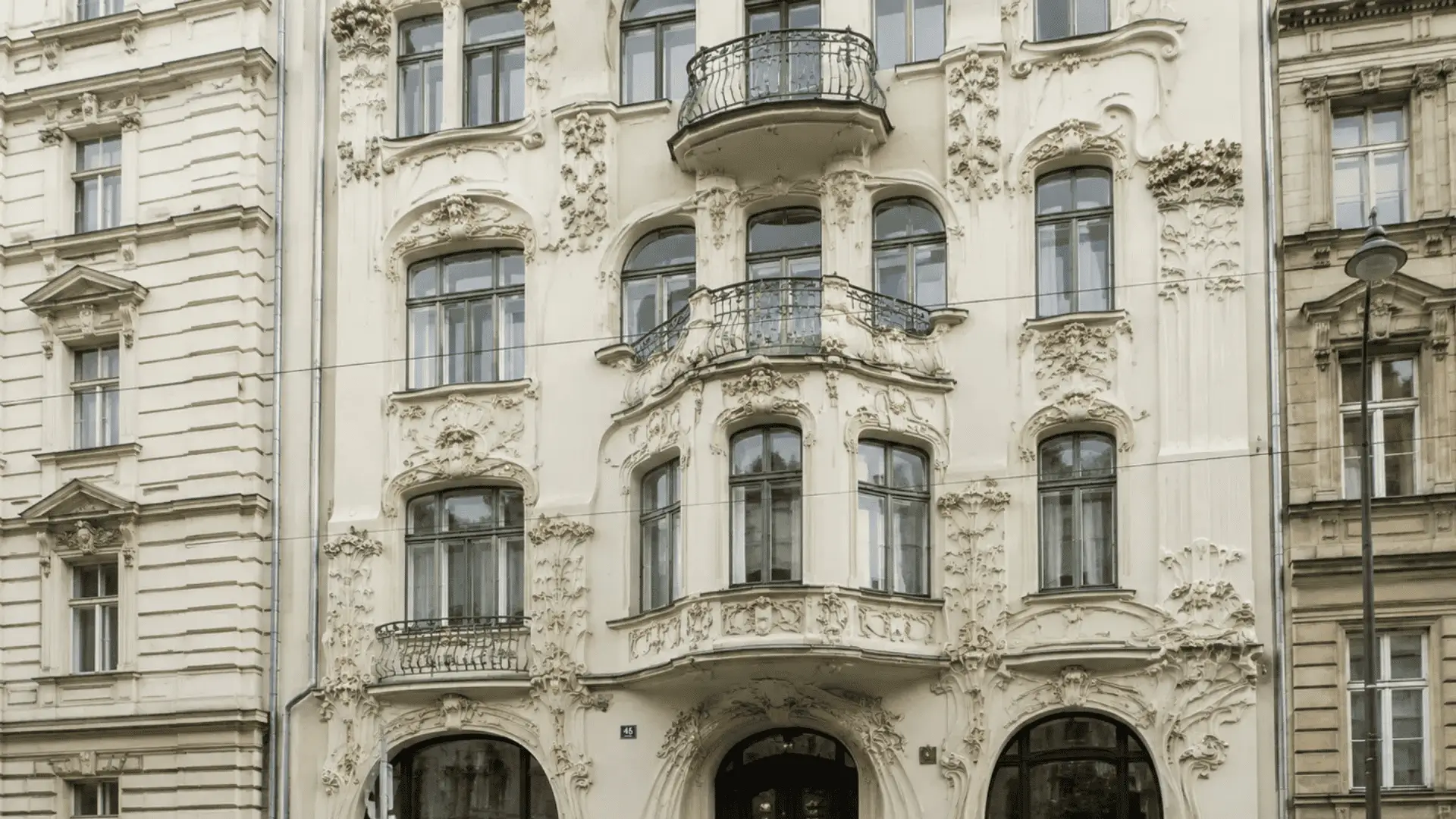 jugendstil facade with sinuous floral stucco ornament and curved wrought iron balconies