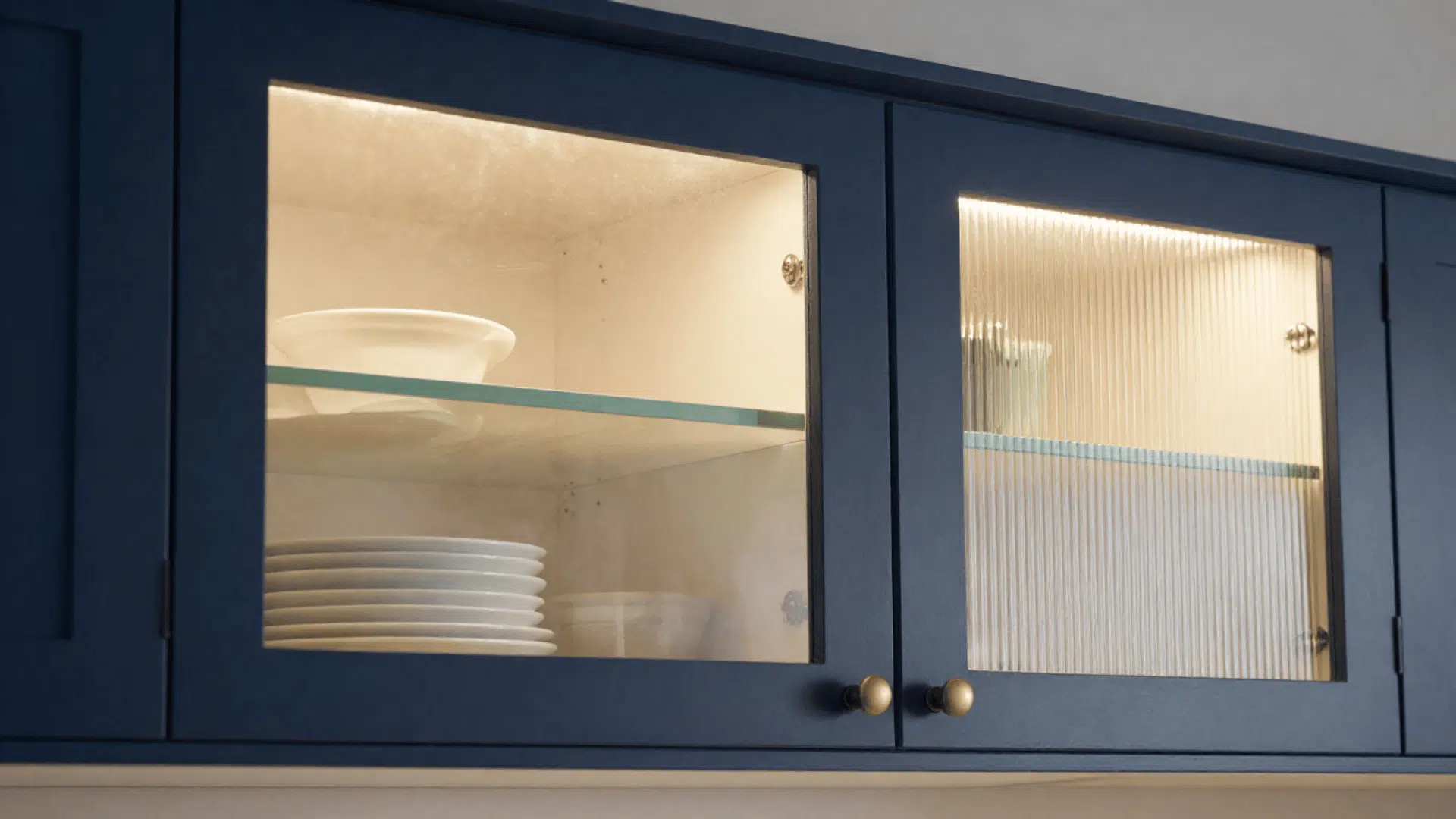 kitchen upper cabinets with mixed clear frosted and ribbed glass door panels showing dishware inside