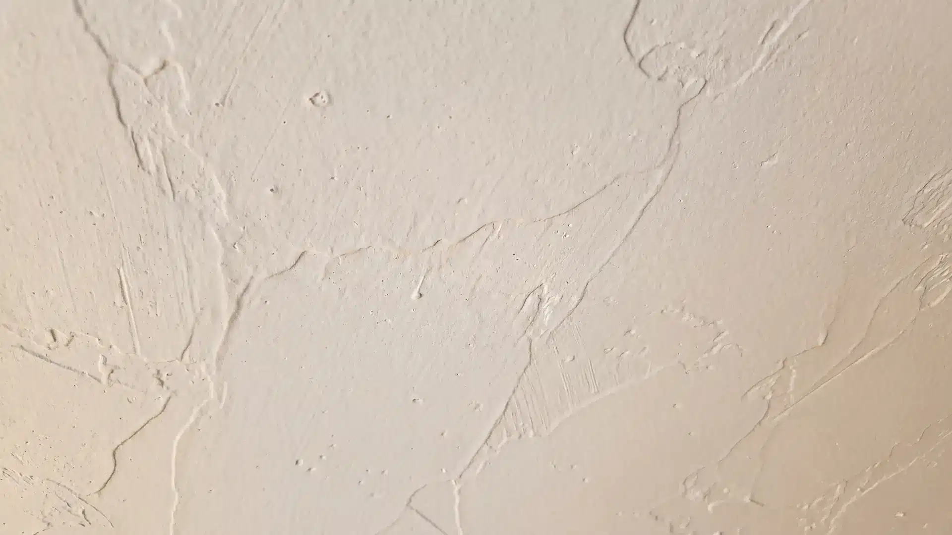 knockdown ceiling texture with flattened spray compound creating a soft irregular pattern