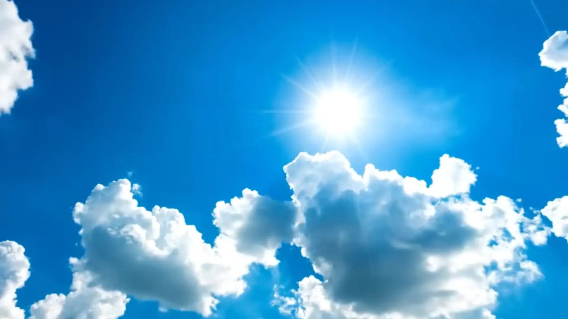 bright sun over white clouds in a blue sky showing good dry weather for painting outsidebright sun over white clouds in a blue sky showing good dry weather for painting outside