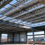 metal roof purlins spanning across trusses during construction of a steel building
