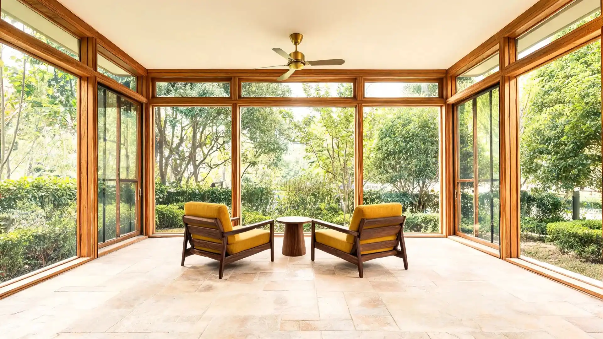 two walnut armchairs with mustard yellow cushions angled toward a small round side table on stone tile