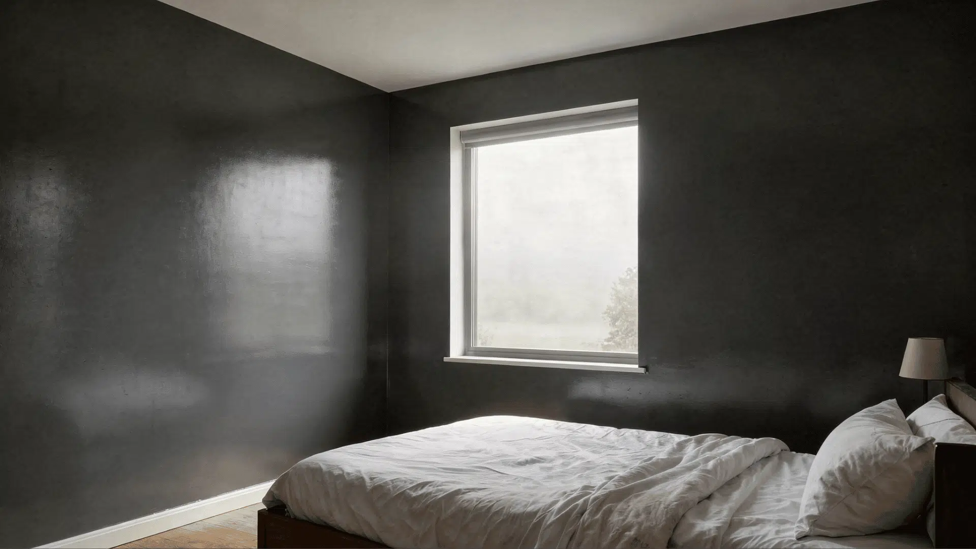 modern bedroom with a made bed covered in white linen a window with a view of trees and a bedside lamp with satin finish